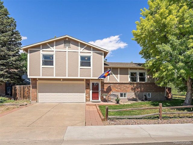 11399 Kendall St, Westminster, CO 80020 - view of front of property with an attached garage, driveway, brick siding, and stucco siding