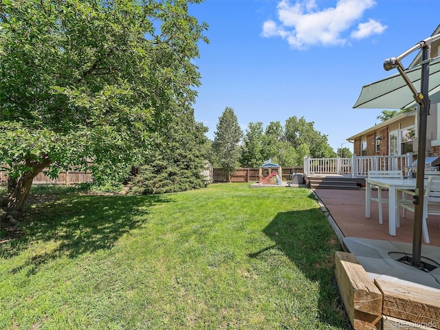 11399 Kendall St, Westminster, CO 80020 - fenced backyard featuring a playground, a wooden deck, and a patio