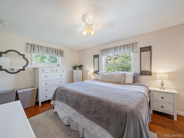 11399 Kendall St, Westminster, CO 80020 - bedroom featuring multiple windows and wood finished floors