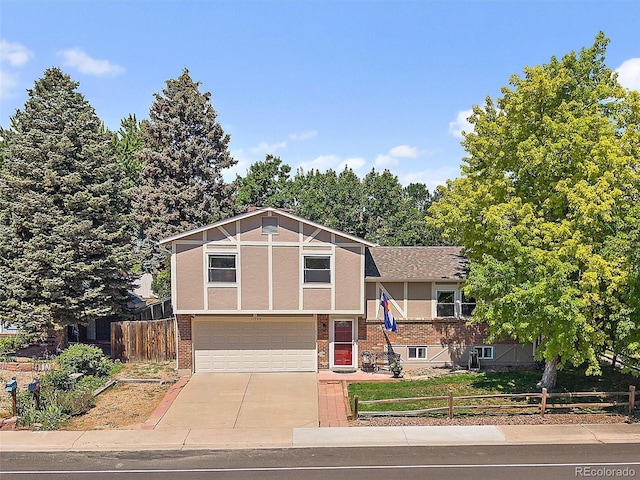 11399 Kendall St, Westminster, CO 80020 - view of front of home with a garage, driveway, stucco siding, and roof with shingles