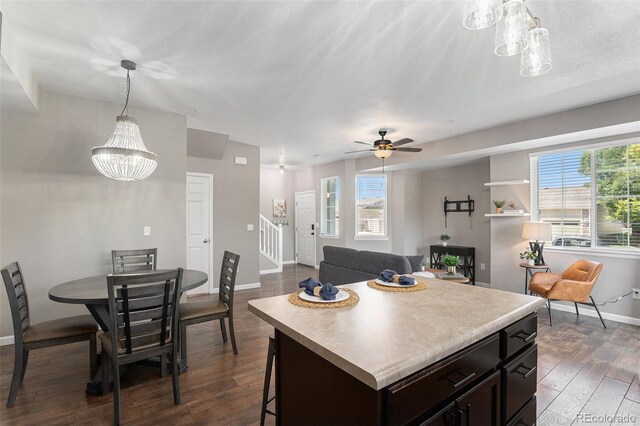 15800 E 121st Ave Unit 3, Brighton, CO 80603 - kitchen with dark wood-style flooring, healthy amount of natural light, light countertops, and a chandelier