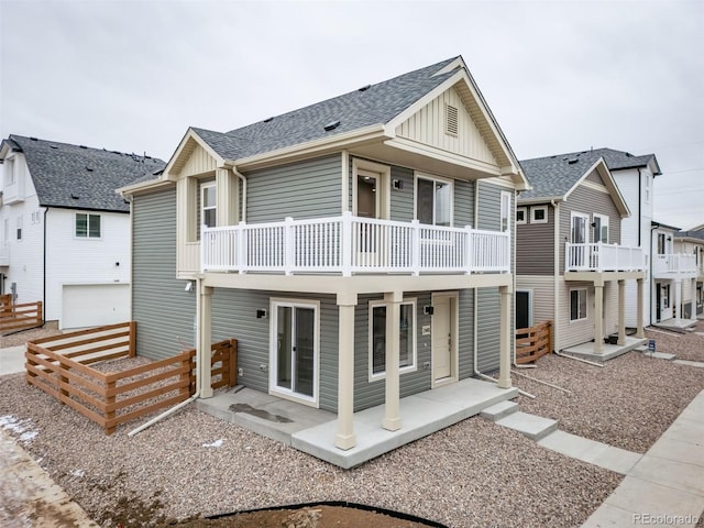 46530 Avery Ln, Bennett, CO 80102 - back of house with a balcony, board and batten siding, and roof with shingles