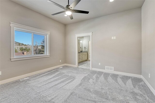 empty room featuring light colored carpet and ceiling fan