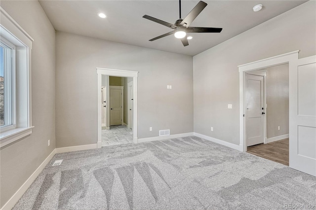 unfurnished room with light carpet and ceiling fan