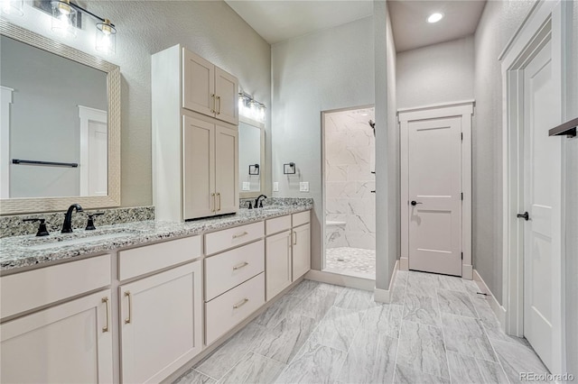 bathroom featuring vanity and tiled shower