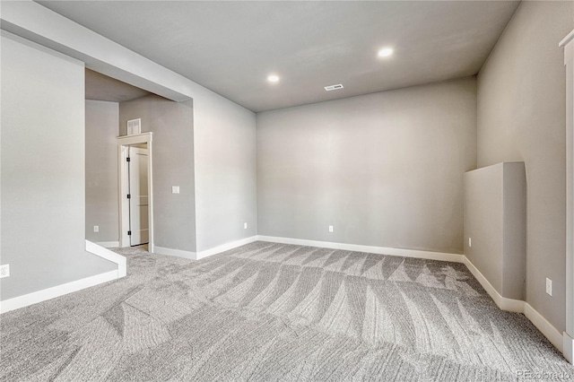 unfurnished room featuring light carpet