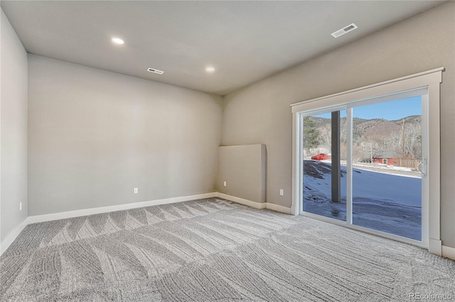 carpeted empty room with a mountain view