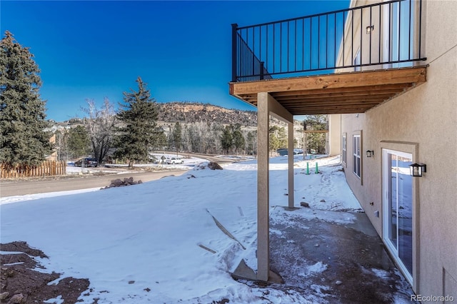 snowy yard with a mountain view