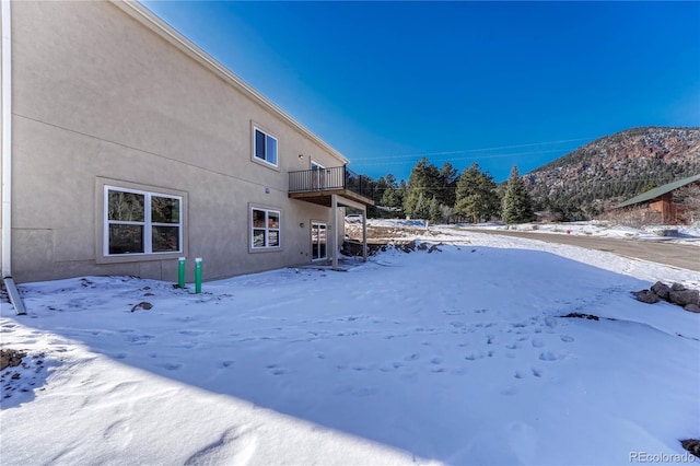 yard covered in snow with a mountain view