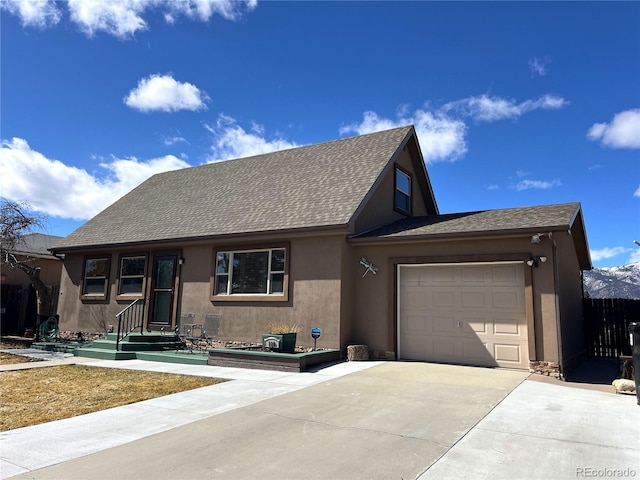 view of front of property with driveway, a shingled roof, an attached garage, and stucco siding