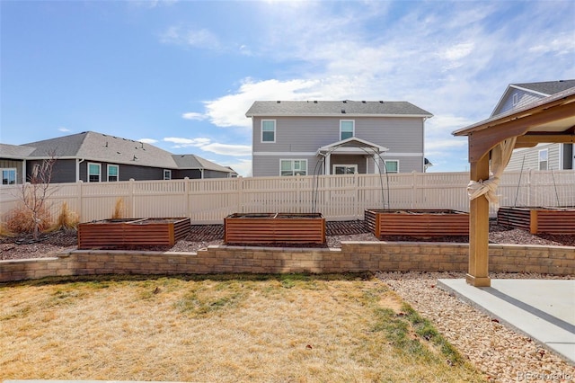 view of yard featuring a vegetable garden and fence