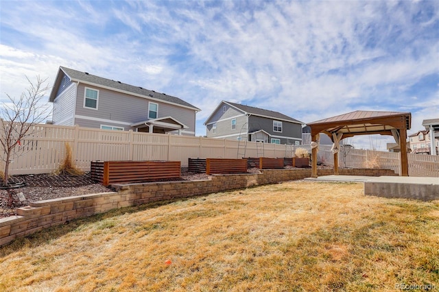 view of yard featuring a gazebo and a fenced backyard