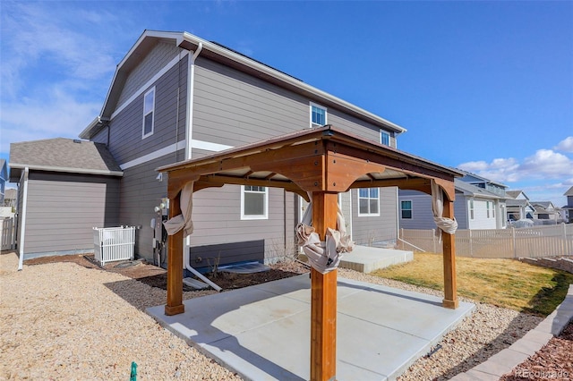 exterior space with a patio, cooling unit, fence, a gazebo, and a residential view