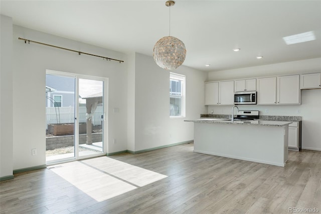 kitchen featuring a wealth of natural light, light wood-style floors, and appliances with stainless steel finishes