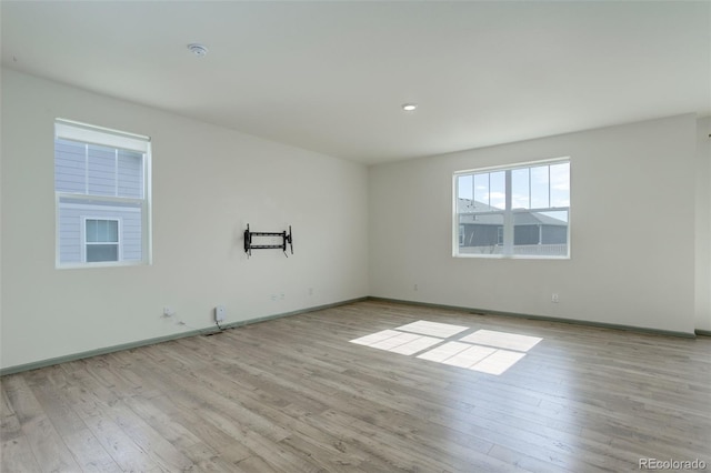 empty room with baseboards and wood finished floors