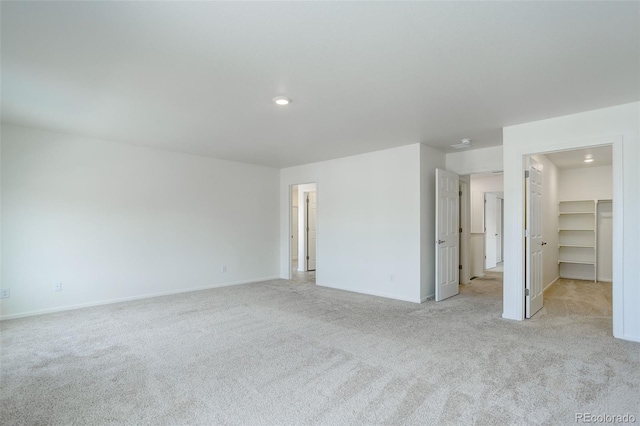 empty room with baseboards and light carpet