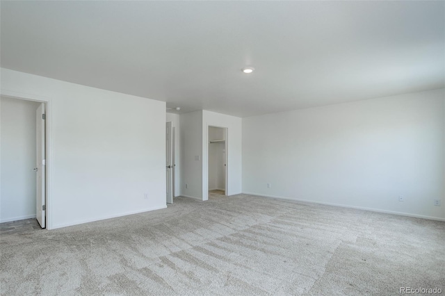 carpeted empty room with recessed lighting and baseboards