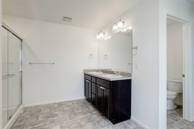 bathroom with toilet, baseboards, visible vents, and a sink