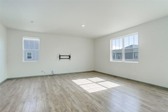 empty room with baseboards and wood finished floors