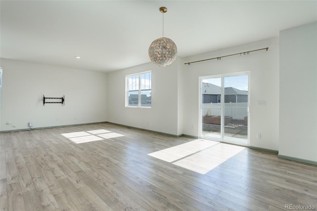 empty room with baseboards and wood finished floors