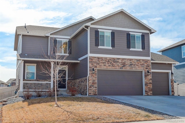 craftsman-style home with a porch, an attached garage, fence, and driveway