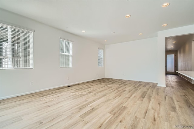 empty room featuring light wood-style flooring, recessed lighting, and a healthy amount of sunlight