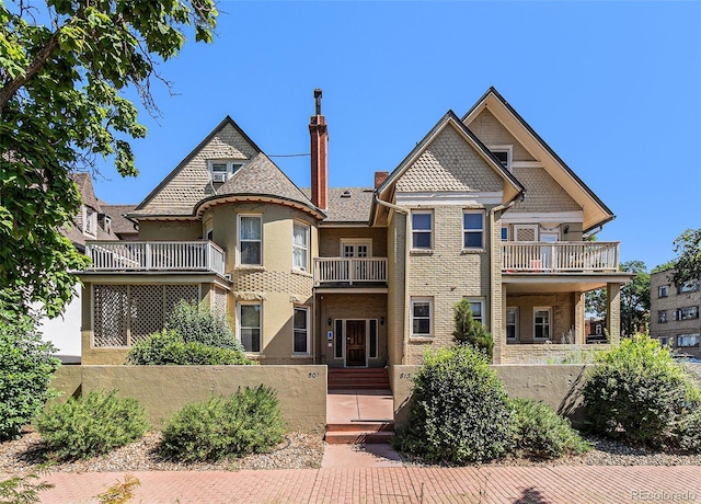 813 E 14th Ave Unit 4, Denver, CO 80218 - view of front facade with a balcony, a chimney, and brick siding