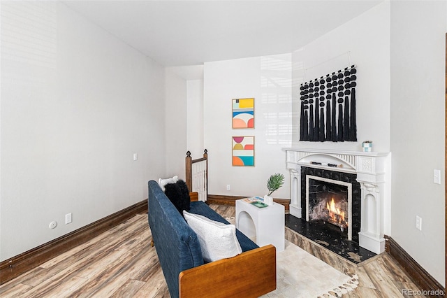 813 E 14th Ave Unit 4, Denver, CO 80218 - sitting room featuring wood finished floors, a fireplace, and an upstairs landing
