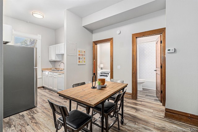 813 E 14th Ave Unit 4, Denver, CO 80218 - dining space featuring light wood finished floors and baseboards