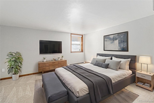 813 E 14th Ave Unit 4, Denver, CO 80218 - bedroom featuring light colored carpet and a baseboard radiator