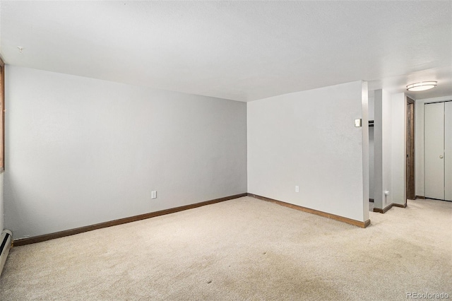 813 E 14th Ave Unit 4, Denver, CO 80218 - unfurnished room featuring light carpet and a baseboard heating unit