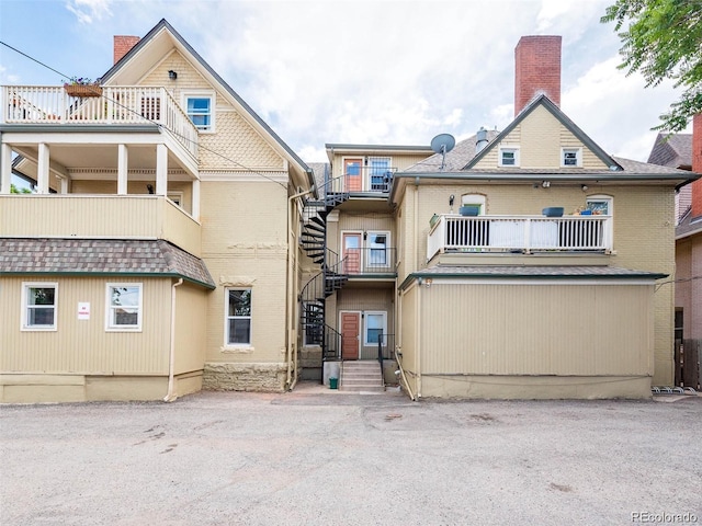 813 E 14th Ave Unit 4, Denver, CO 80218 - view of front of home with stairs, brick siding, a chimney, and a balcony