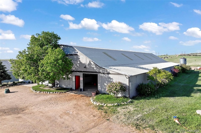 1705 Outter Marker Rd, Castle Rock, CO 80108 - view of front facade featuring a garage, an outbuilding, a front yard, metal roof, and dirt driveway
