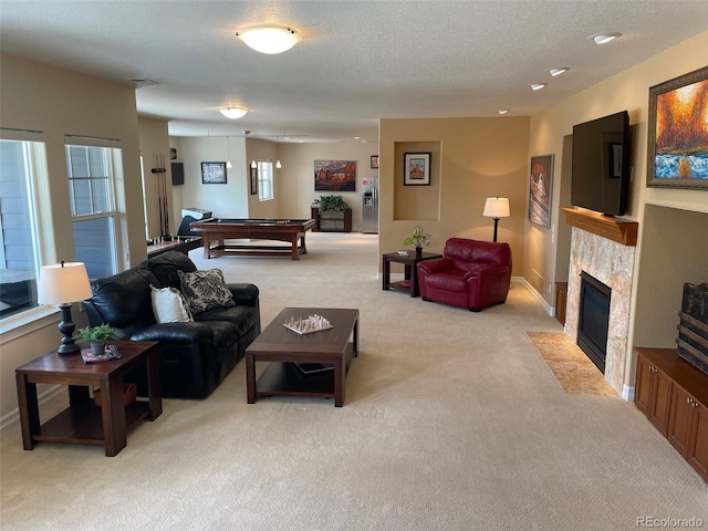 7003 S Irvington Ct, Aurora, CO 80016 - living area with light colored carpet, pool table, a fireplace with flush hearth, and a textured ceiling