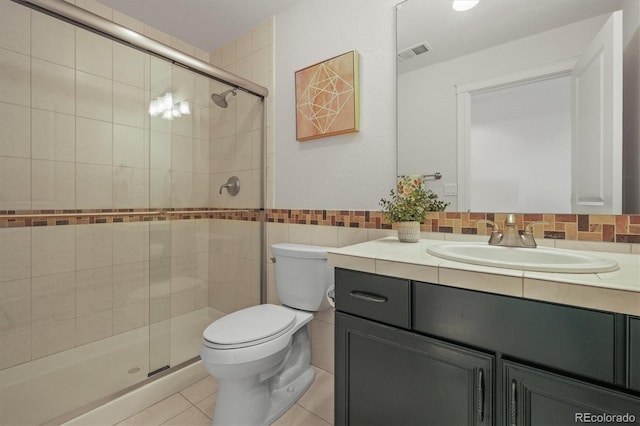 7003 S Irvington Ct, Aurora, CO 80016 - bathroom featuring vanity, a shower stall, tile patterned floors, and tile walls
