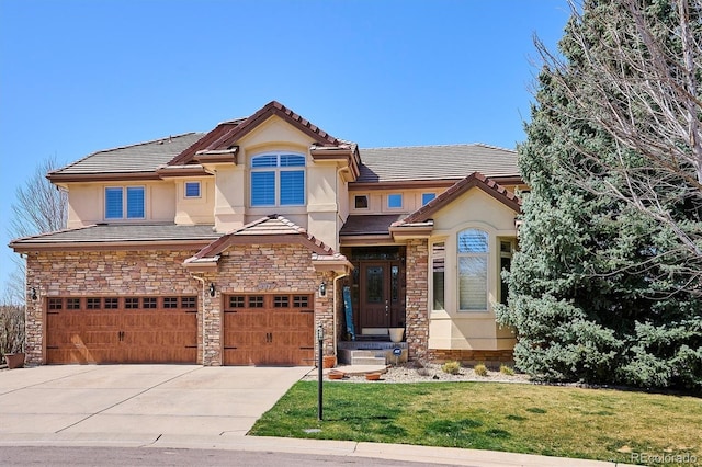 6971 S Netherland Way, Aurora, CO 80016 - view of front of property with a tile roof, concrete driveway, a front lawn, a garage, and stucco siding