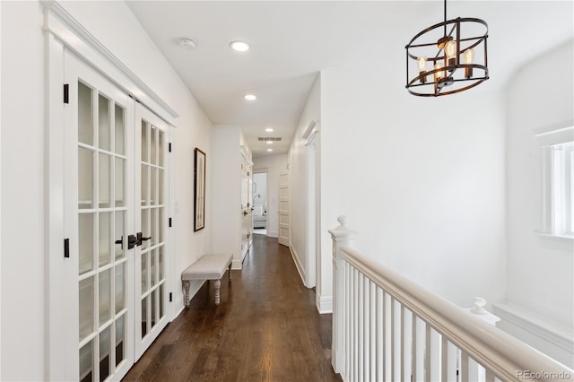 corridor with visible vents, dark wood-style floors, recessed lighting, french doors, and a chandelier