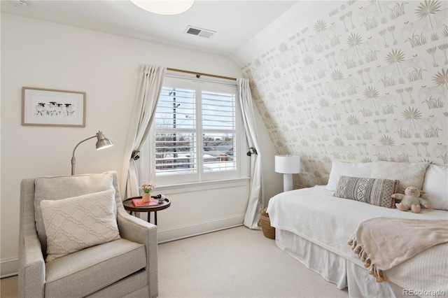 bedroom with baseboards, wallpapered walls, lofted ceiling, an accent wall, and carpet flooring