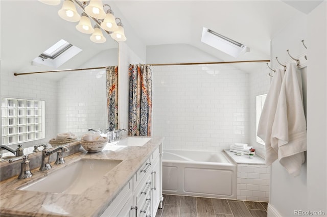 full bath featuring a sink, lofted ceiling with skylight, and shower / bath combo