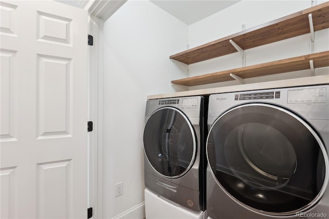 washroom featuring laundry area and washer and clothes dryer