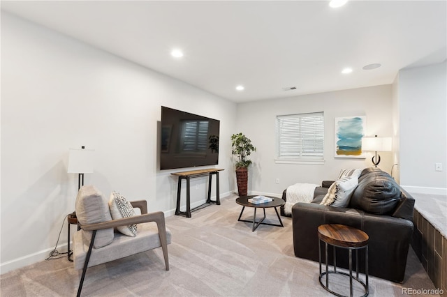 living room featuring recessed lighting, light colored carpet, and baseboards