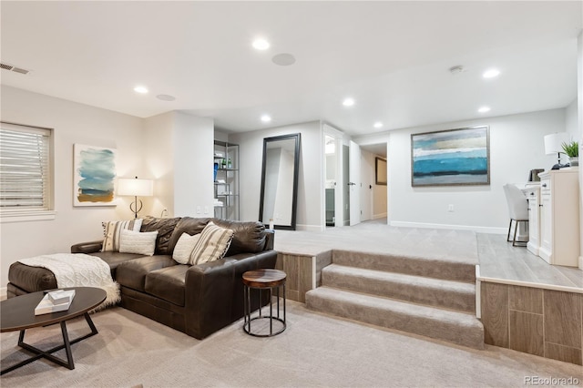 sunken living room featuring light colored carpet, recessed lighting, visible vents, and baseboards