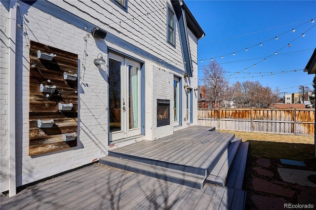 wooden deck featuring fence and french doors