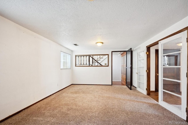 basement with light carpet and a textured ceiling