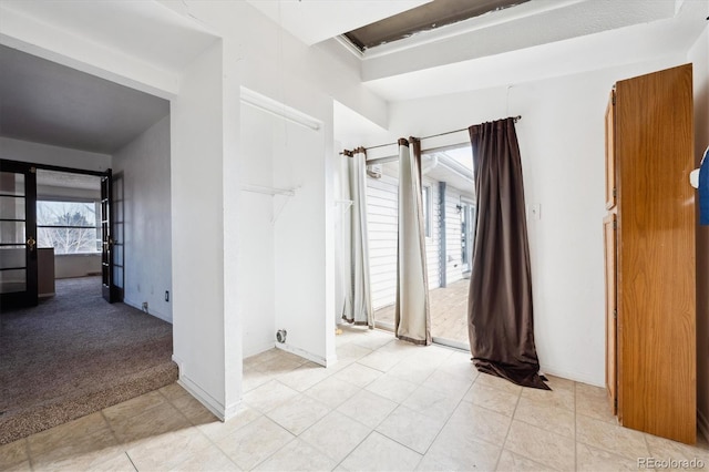 spare room with plenty of natural light and light carpet