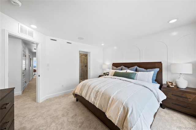 bedroom featuring baseboards, visible vents, and light carpet