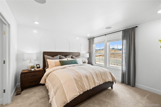 bedroom featuring light colored carpet, recessed lighting, and baseboards