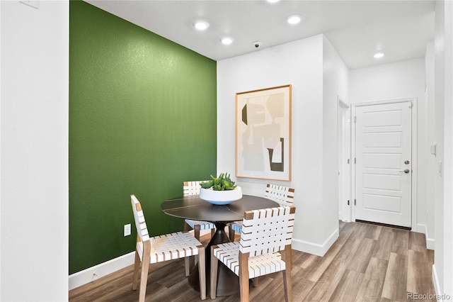 dining area with baseboards, recessed lighting, and light wood finished floors