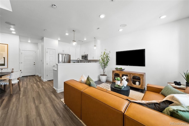living room with recessed lighting, dark wood finished floors, and baseboards