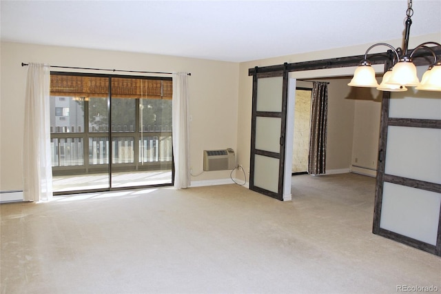 carpeted spare room with a notable chandelier, baseboard heating, a barn door, a wall mounted AC, and baseboards